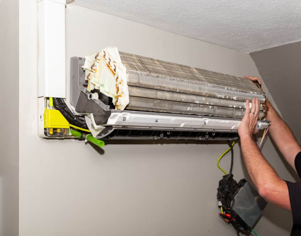 Repairman Working On Air Conditioner Mini Split System