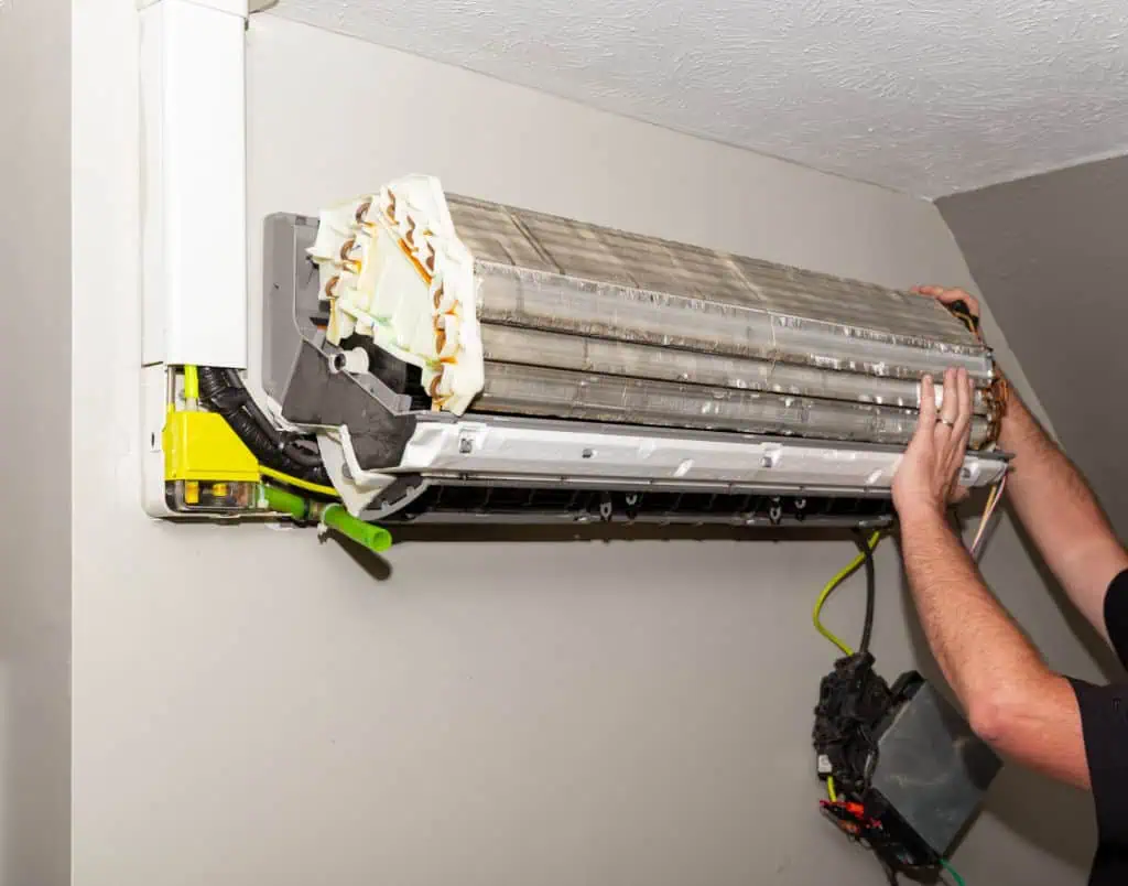 Repairman Working On Air Conditioner Mini Split System Repairman Working On Air Conditioner Mini Split System